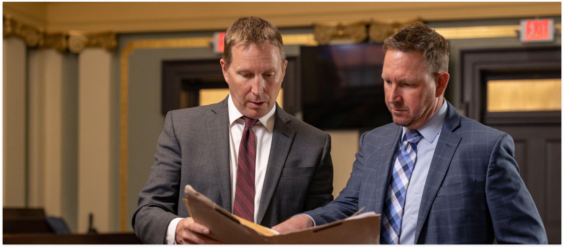 Two trial lawyers reviewing a case document